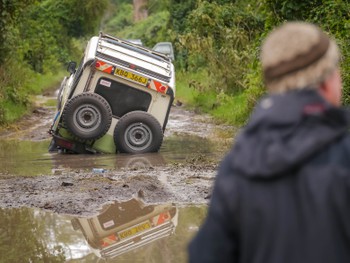 The 4WD that helped tow the van out gets super bogged