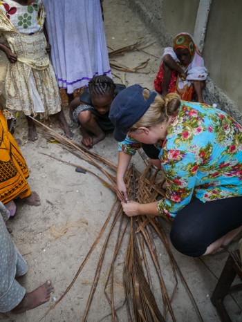 Amanda making building materials out of palm leaf